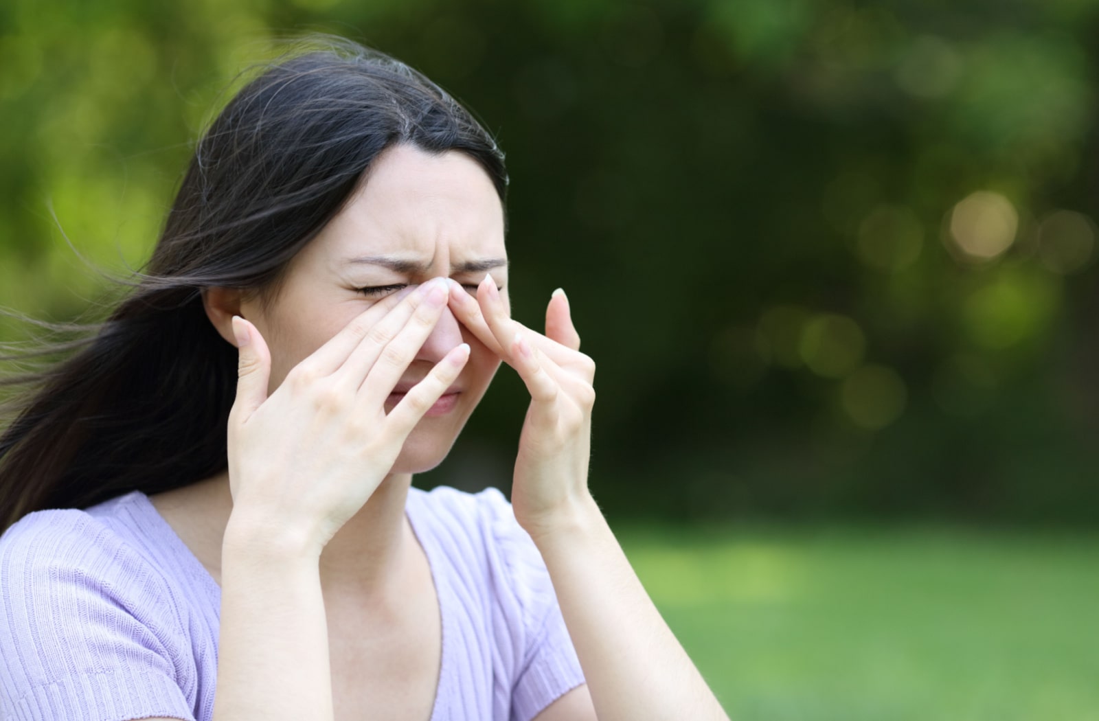 A woman rubbing her eyes due to dryness