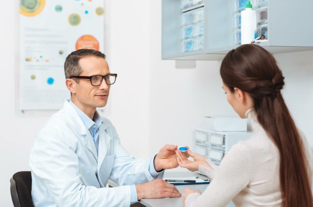 A patient explores a lens option suitable for dry eyes with their optometrist during their contact lens fitting.