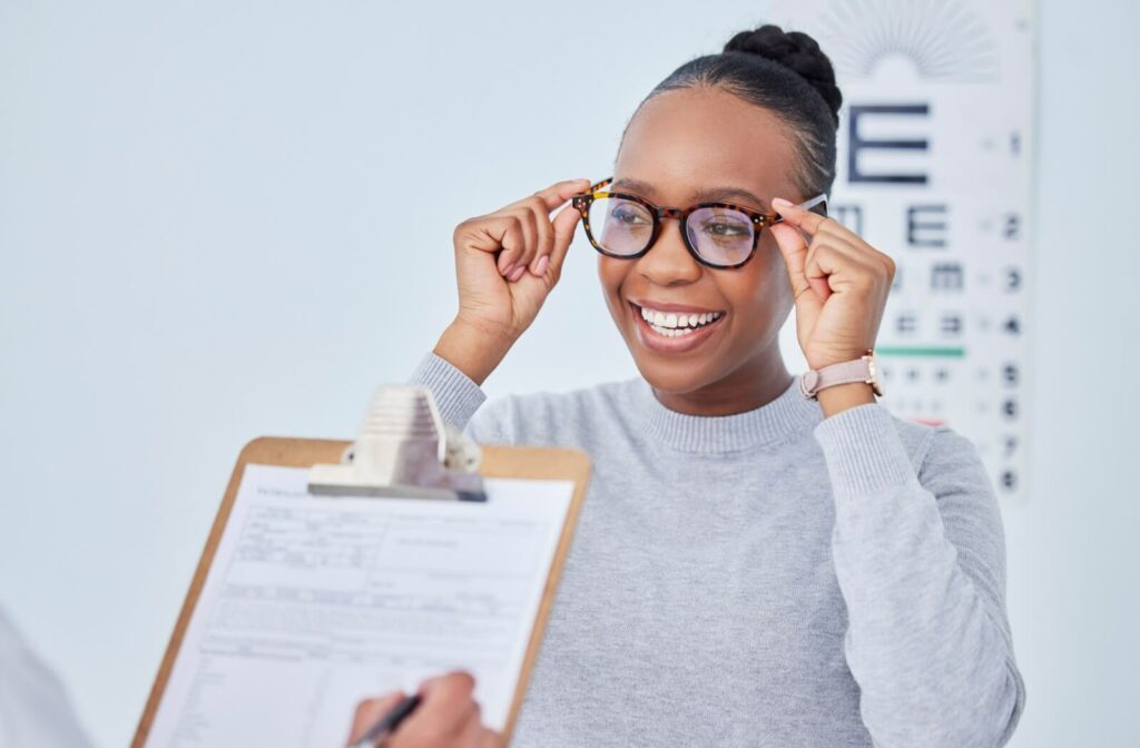 Someone tests their prescription lenses during an eye exam with an optometrist.
