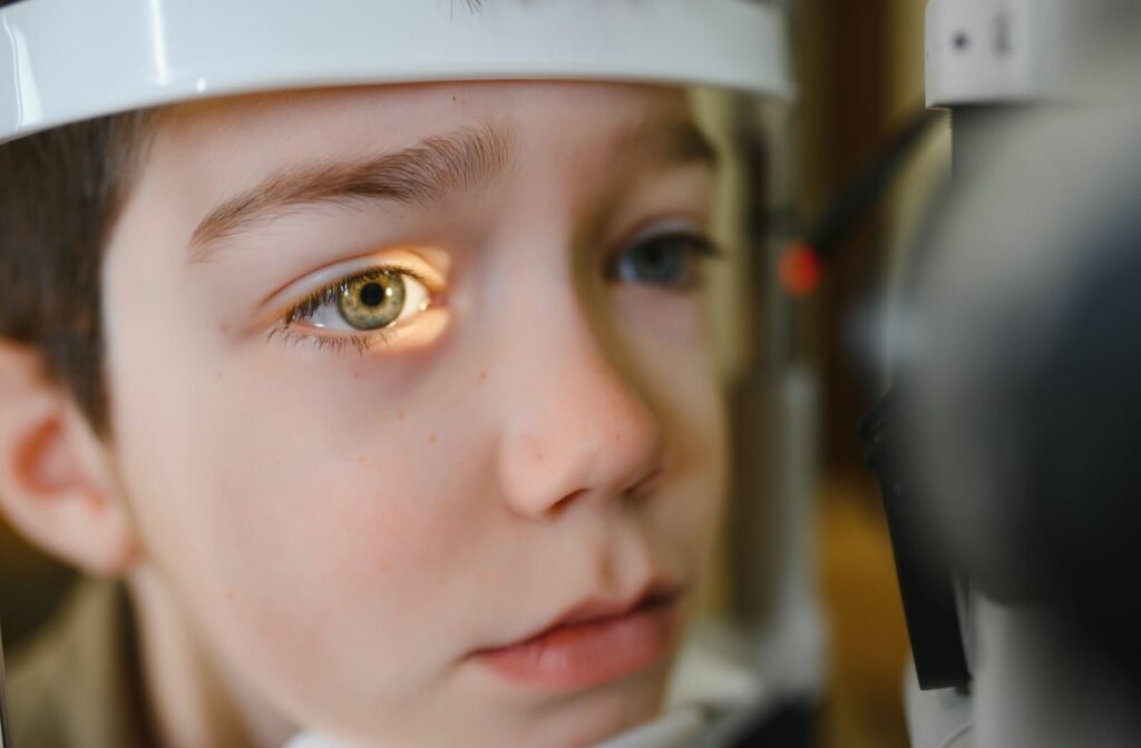 A child undergoing a professional eye exam to determine eligibility for overnight vision correction lenses (Orthokeratology).